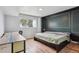 Bedroom featuring a bed, desk, and large window providing natural light at 579 Wright St # 204, Lakewood, CO 80228