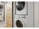 This laundry room features a stacked washer and dryer and a sliding door with a mirror at 579 Wright St # 204, Lakewood, CO 80228