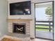 Close-up of fireplace, tv and sliding glass doors leading to a balcony at 579 Wright St # 204, Lakewood, CO 80228