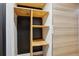 A storage space is displayed here, featuring bare wooden shelves and a back wall painted black at 579 Wright St # 204, Lakewood, CO 80228