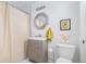Compact bathroom featuring a vanity sink, octagonal mirror, and neutral finishes at 3110 N Franklin St, Denver, CO 80205