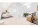 Spacious bedroom with natural light, neutral carpet, and a seating area with a writing desk at 3110 N Franklin St, Denver, CO 80205