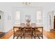 Dining room with hardwood floors, woven chairs, and a modern chandelier at 3110 N Franklin St, Denver, CO 80205
