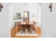 Bright dining room with modern chandelier, hardwood floors, and woven chairs at 3110 N Franklin St, Denver, CO 80205