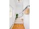 Bright entryway with white walls and stairs featuring carpet and wooden handrails at 3110 N Franklin St, Denver, CO 80205