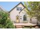 Charming home featuring a quaint front porch, a yellow door, and well-maintained landscaping at 3110 N Franklin St, Denver, CO 80205