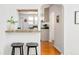 Kitchen pass through with stone counter top, white cabinets, and bar stool seating at 3110 N Franklin St, Denver, CO 80205