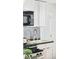 Close-up of the kitchen featuring stainless steel appliances and white cabinets at 3110 N Franklin St, Denver, CO 80205