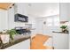 Bright kitchen with stainless steel appliances, white cabinets, and ample counter space at 3110 N Franklin St, Denver, CO 80205