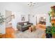 Spacious living room with hardwood floors, modern sofa, and a view to the dining room at 3110 N Franklin St, Denver, CO 80205