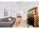 Open living room leading to dining area, featuring hardwood floors and a fireplace at 3110 N Franklin St, Denver, CO 80205