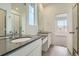 Bright bathroom with dual sinks, quartz countertops, tile flooring, and a large mirror at 917 W Beverly St, Elizabeth, CO 80107