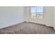 Cozy bedroom with carpet flooring, a large window, and plenty of natural light at 917 W Beverly St, Elizabeth, CO 80107