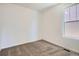 Bright bedroom with plush carpeting and a large window providing plenty of natural light at 917 W Beverly St, Elizabeth, CO 80107