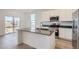This island kitchen features stainless steel appliances, modern finishes and a breakfast bar at 917 W Beverly St, Elizabeth, CO 80107