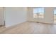 Bright, airy living room featuring hardwood floors, large windows, and a view of the outdoors at 917 W Beverly St, Elizabeth, CO 80107