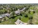 Aerial view of the property showing surrounding neighborhood, mature trees, and spacious backyard at 1153 S Biscay St, Aurora, CO 80017