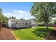 Expansive backyard featuring a wooden deck, lush lawn, and mature shade trees at 1153 S Biscay St, Aurora, CO 80017
