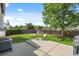 Serene backyard patio with seating area, lush lawn, and mature trees creating a peaceful retreat at 1153 S Biscay St, Aurora, CO 80017