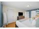 Light-filled bedroom with bamboo floors, television, and plush bed at 1153 S Biscay St, Aurora, CO 80017