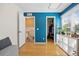 Bedroom featuring a walk in closet, blue walls, and wood floors at 1153 S Biscay St, Aurora, CO 80017