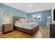 Comfortable bedroom featuring a large bed, ample natural light, and wood nightstands at 1153 S Biscay St, Aurora, CO 80017