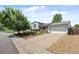 Charming home with brick accents, landscaped front yard, and a two-car garage with a paved driveway at 1153 S Biscay St, Aurora, CO 80017