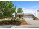 Charming home with brick accents, landscaped front yard, and a two-car garage with a paved driveway at 1153 S Biscay St, Aurora, CO 80017