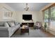 Comfortable living room featuring a gray sofa, stylish decor, and a large TV for entertainment at 1153 S Biscay St, Aurora, CO 80017