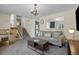 Cozy living room featuring a gray sofa, wood coffee table, and staircase at 1153 S Biscay St, Aurora, CO 80017