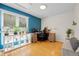 Bright home office featuring hardwood floors, white shelves, and a built-in desk space at 1153 S Biscay St, Aurora, CO 80017