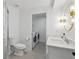 Bright bathroom with a modern vanity, stylish lighting, and access to a laundry room at 21 Birdie Ln, Littleton, CO 80123