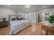 Comfortable bedroom with natural light, hardwood floors, and access to bathroom at 21 Birdie Ln, Littleton, CO 80123
