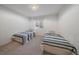 Bright bedroom with matching twin beds, carpeted floors, and a window for natural light at 21 Birdie Ln, Littleton, CO 80123