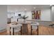 Dining area with modern table and chairs, plus a view of the contemporary kitchen at 21 Birdie Ln, Littleton, CO 80123