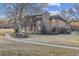 Charming brick home featuring a well-maintained lawn and mature landscaping at 21 Birdie Ln, Littleton, CO 80123