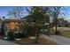 Charming brick home featuring a well-maintained lawn and inviting front entrance with an elevated porch and gray shingles at 21 Birdie Ln, Littleton, CO 80123