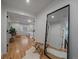Hallway with a bedroom view, hardwood floors, and a decorative mirror at 21 Birdie Ln, Littleton, CO 80123