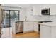 Bright kitchen with white cabinets, stainless steel appliances, and a modern gold faucet at 21 Birdie Ln, Littleton, CO 80123
