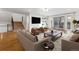 Open-concept living room featuring a comfortable sofa, armchairs, and large windows at 21 Birdie Ln, Littleton, CO 80123