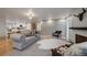 Spacious living area with a modern fireplace, seating, and connection to kitchen at 21 Birdie Ln, Littleton, CO 80123
