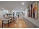 Bright and airy living space connecting the dining area, kitchen and stairwell at 21 Birdie Ln, Littleton, CO 80123