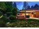 Secluded backyard featuring a hot tub, covered patio, and lush landscaping at 250 S Dahlia St, Denver, CO 80246