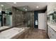 Luxurious bathroom featuring marble accents, a glass shower, and soaking tub at 250 S Dahlia St, Denver, CO 80246