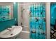 Cozy bathroom with a blue curtain, shower and sink at 250 S Dahlia St, Denver, CO 80246