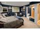 Cozy carpeted bedroom with a workspace, sofa, and access to the bathroom with a toilet and sink at 250 S Dahlia St, Denver, CO 80246
