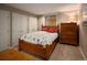 Charming bedroom with a classic wooden bed, dresser, and ample closet space, perfect for restful nights at 250 S Dahlia St, Denver, CO 80246