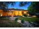Home exterior with manicured landscaping, a rock garden, and charming facade at 250 S Dahlia St, Denver, CO 80246
