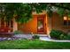 Inviting front entrance with a red door, cozy seating and landscaped garden at 250 S Dahlia St, Denver, CO 80246
