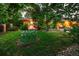 Landscaped front yard with flowers, lush greenery, and a charming facade at 250 S Dahlia St, Denver, CO 80246